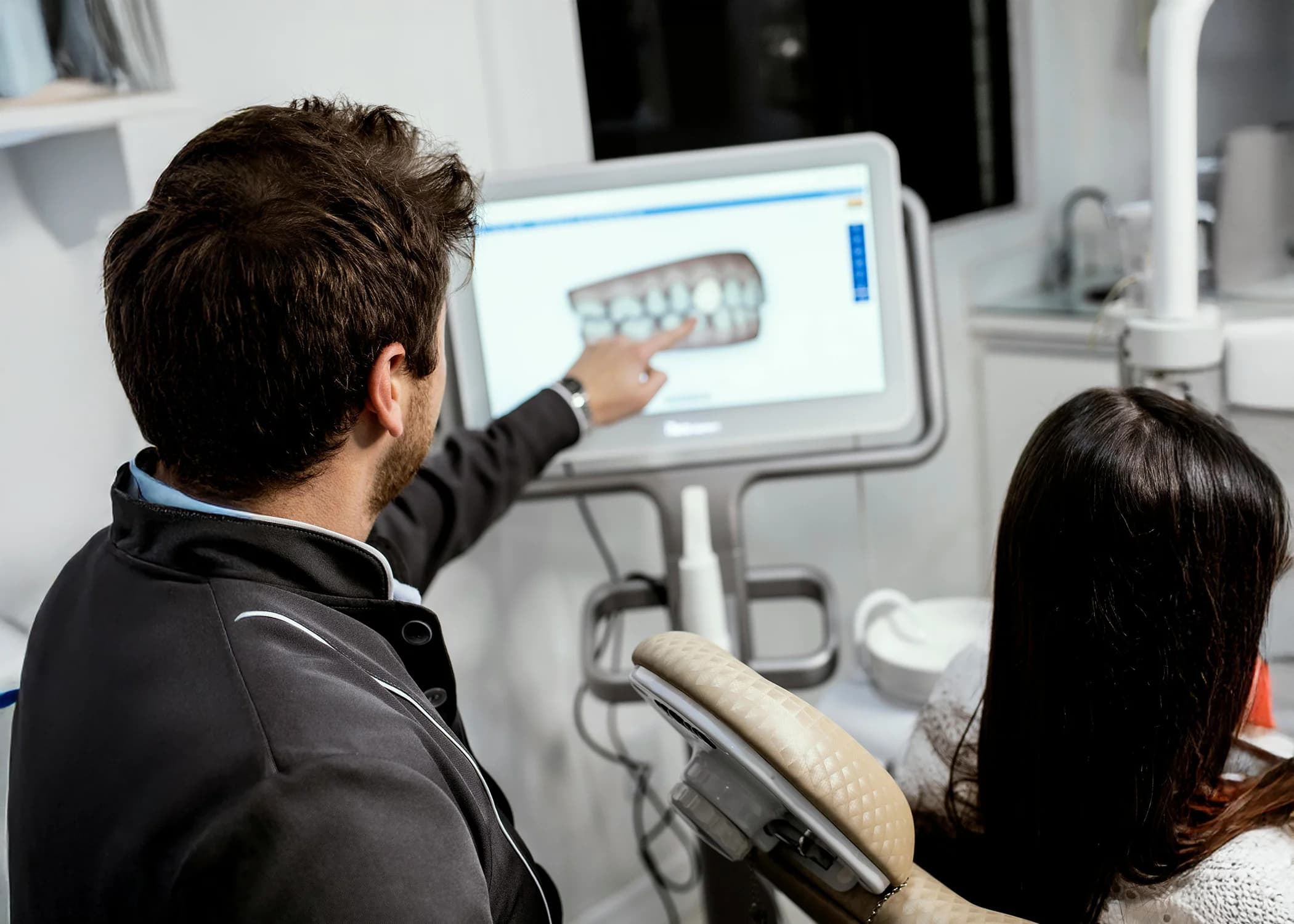 Dentist showing patient a dental model