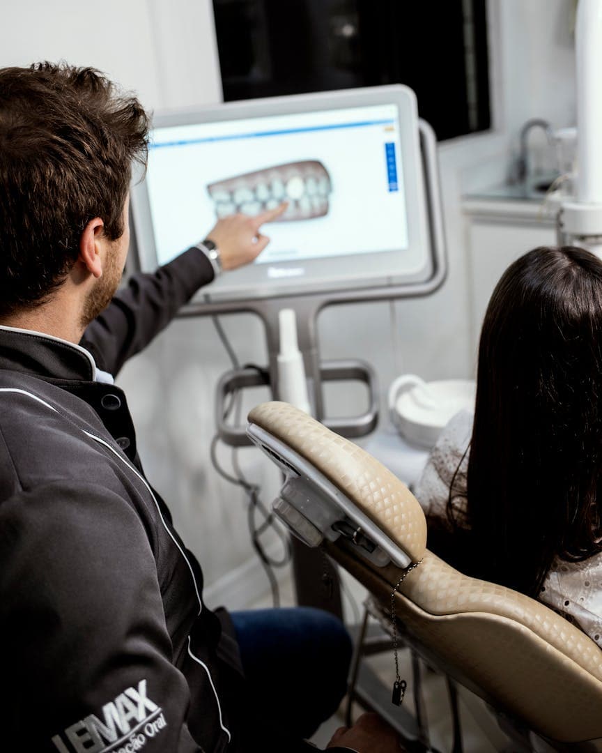 Dentist walking a patient through a digital scan of her teeth